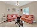 Inviting living room featuring neutral walls, tile floors, and comfortable seating area at 1692 Blue Grass Blvd, Deland, FL 32724