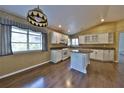 Bright kitchen features an island, granite countertops, stainless steel appliances, and wood floors at 247 W Sabal Palm Pl, Longwood, FL 32779