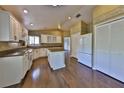 Bright kitchen features an island, granite countertops, stainless steel appliances, and wood floors at 247 W Sabal Palm Pl, Longwood, FL 32779