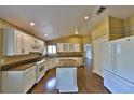 Bright kitchen features an island, granite countertops, stainless steel appliances, and wood floors at 247 W Sabal Palm Pl, Longwood, FL 32779