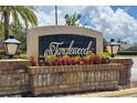 The Tanglewood neighborhood entrance sign is framed by colorful flowers and stately lantern fixtures at 2638 Clarinet Dr, Orlando, FL 32837
