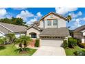 Beautiful two-story home featuring a spacious driveway and lush landscaping, enhancing its curb appeal at 2638 Clarinet Dr, Orlando, FL 32837