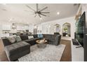 Spacious living room featuring hardwood floors, a large sectional sofa, and modern décor at 2896 Matera Dr, St Cloud, FL 34771