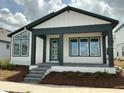 Stylish single-story home boasts a charming covered porch and complemented by modern design elements and landscaping at 2971 Embark Trail, St Cloud, FL 34771