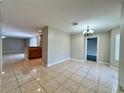 Open-concept dining room area showcasing tile flooring and seamless flow into the kitchen at 306 Snook Way, Kissimmee, FL 34759
