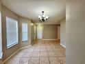 Open dining room featuring tiled floors and an elegant chandelier at 306 Snook Way, Kissimmee, FL 34759