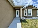Up close view of the front door and front window of the home at 306 Snook Way, Kissimmee, FL 34759