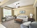 Inviting living room with plush seating, ceiling fan, and bay window at 3100 Pine Needle Trl, Kissimmee, FL 34746