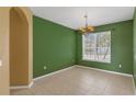 Inviting dining room featuring a large window, and tile flooring at 3131 Regal Darner Dr, Kissimmee, FL 34744