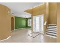 Bright foyer features tile flooring, high ceilings, and decorative staircase at 3131 Regal Darner Dr, Kissimmee, FL 34744