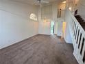 Spacious living room featuring high ceilings, lots of natural light, and a staircase at 3352 Hamlet Loop, Winter Park, FL 32792