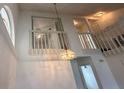 Bright living room featuring high ceilings, lots of natural light, and a decorative chandelier at 3352 Hamlet Loop, Winter Park, FL 32792