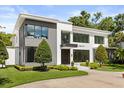Contemporary home featuring a striking facade, manicured lawn, and modern architectural details at 350 Northwind Rd, Maitland, FL 32751
