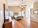 Bright bedroom featuring wood floors, a ceiling fan, and an ensuite bathroom at 3708 Beaver Ridge Dr, Orlando, FL 32829