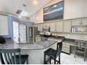 Stylish kitchen with granite countertops, stainless steel appliances, and a breakfast bar at 3708 Beaver Ridge Dr, Orlando, FL 32829