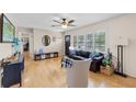 Bright living room with hardwood floors, ceiling fan, and large windows offering natural light and backyard views at 3722 Neptune Dr, Orlando, FL 32804