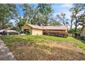 Charming single-story home with a stone facade and well-maintained front yard at 4799 Lighthouse Rd, Orlando, FL 32808