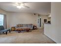 A cozy living room with carpet, a ceiling fan, natural light, and neutral paint at 6029 Westgate Dr # 726, Orlando, FL 32835