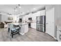 Modern eat-in kitchen featuring stainless steel appliances, large island and hardwood floors at 640 Bayern Ln, Debary, FL 32713