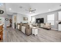 Spacious living room with hardwood floors, a comfy couch, tv and fireplace at 640 Bayern Ln, Debary, FL 32713
