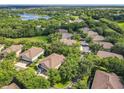 Stunning aerial view of a residential neighborhood with tree-lined streets and a serene lake in the distance at 725 Ashworth Overlook Dr # C, Apopka, FL 32712