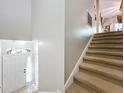 Bright foyer with a white front door, complemented by a staircase leading to the upper level at 725 Ashworth Overlook Dr # C, Apopka, FL 32712