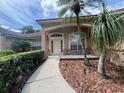 Charming home with a well-lit front entrance and a landscaped walkway at 8012 Old Town Dr, Orlando, FL 32819