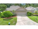 Charming single-story home with a two-car garage and well-maintained lawn at 849 Bentley Green Cir, Winter Springs, FL 32708