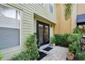 Close-up of the front entrance featuring a black door, brick walkway, and lush green landscaping at 901 E Pine St # 2, Orlando, FL 32801