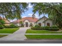 Beautiful single-story home with a well-manicured lawn and vibrant landscaping at 9142 Southern Breeze Dr, Orlando, FL 32836