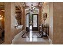Grand foyer with decorative tile flooring, a chandelier, and an ornate console table at 9142 Southern Breeze Dr, Orlando, FL 32836