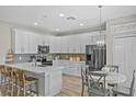 Modern kitchen featuring stainless steel appliances, white cabinets, quartz countertops, and a breakfast nook at 9319 Marsh Oaks Ct, Orlando, FL 32832