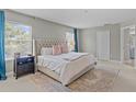 Comfortable bedroom with large windows, neutral colors, and ample space at 9319 Marsh Oaks Ct, Orlando, FL 32832