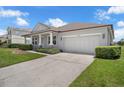 This charming home boasts an attached two-car garage and meticulously maintained landscaping at 10151 Chorlton Cir, Orlando, FL 32832