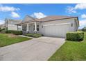 Charming single-story home with a well-manicured lawn, mature landscaping, and a two-car garage at 10151 Chorlton Cir, Orlando, FL 32832