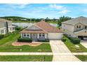 Aerial view of a single-story home with beautiful landscaping and a view of the lake at 10151 Chorlton Cir, Orlando, FL 32832