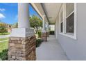 Inviting front porch with stone accents and elegant columns, perfect for relaxing and enjoying the neighborhood at 10151 Chorlton Cir, Orlando, FL 32832