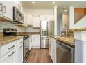 Modern kitchen featuring stainless steel appliances, white cabinets, granite countertops, and subway tile backsplash at 11081 Savannah Landing Cir, Orlando, FL 32832