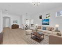 Bright living room with tile flooring, comfortable seating, and art pieces creating a welcoming space at 1122 Sandstone Run, Sanford, FL 32771