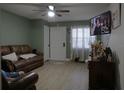 Inviting living room featuring a comfortable leather sofa, a ceiling fan, neutral walls, and natural light at 1211 Phillip St, Winter Springs, FL 32708