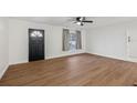 Bright living room with sleek, modern flooring and a ceiling fan for added comfort at 1320 E Lombardy Dr, Deltona, FL 32725