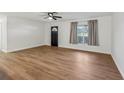 A spacious living room is complemented by a ceiling fan and natural light at 1320 E Lombardy Dr, Deltona, FL 32725