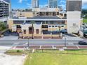 An aerial view showcases the building's design, surrounding streetscape, and the adjacent green space at 151 E Washington St # 424, Orlando, FL 32801