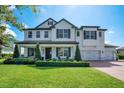 Charming two-story home with a well-manicured lawn, three-car garage, and beautiful curb appeal at 15787 Tangerine Dream Ct, Winter Garden, FL 34787