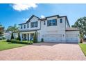 Beautiful two-story home with a three-car garage, lush landscaping, and brick-paved driveway at 15787 Tangerine Dream Ct, Winter Garden, FL 34787