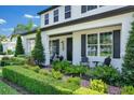 Inviting front porch with seating area, manicured landscaping and brick walkway to the front door at 15787 Tangerine Dream Ct, Winter Garden, FL 34787