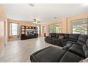 Spacious living room featuring tile floors, natural light, and a large sectional couch with cozy throw pillows at 2512 Chapala Dr, Kissimmee, FL 34746