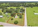 Expansive aerial view showcases property lines, surrounding landscape, and road access at 28 N Osceola Ave, Center Hill, FL 33514