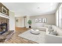 Inviting living room featuring a stone fireplace, hardwood floors, and contemporary decor at 28 N Osceola Ave, Center Hill, FL 33514