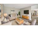 A sun-filled living room featuring a cozy sofa and a modern entertainment center at 4209 Sw 33Rd St, Ocala, FL 34474